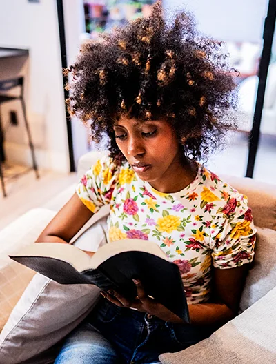 A person reading comfortably at home