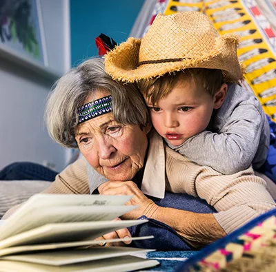 An adult and child reading together